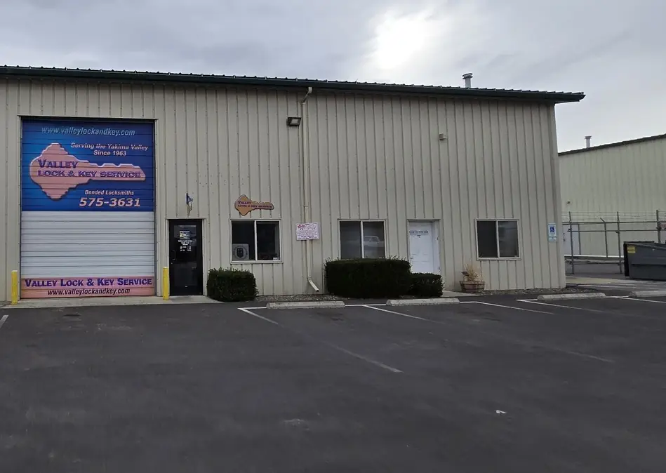 Valley Lock & Key's royal-blue roll-up door with the gold key sign and the glass entry door
