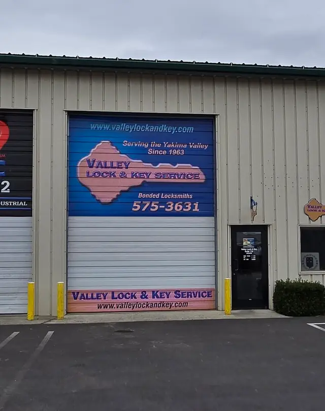 The Valley Lock & Key roll-up door sign, Serving the Yakima Valley Since 1963, beside the shop's glass entry door